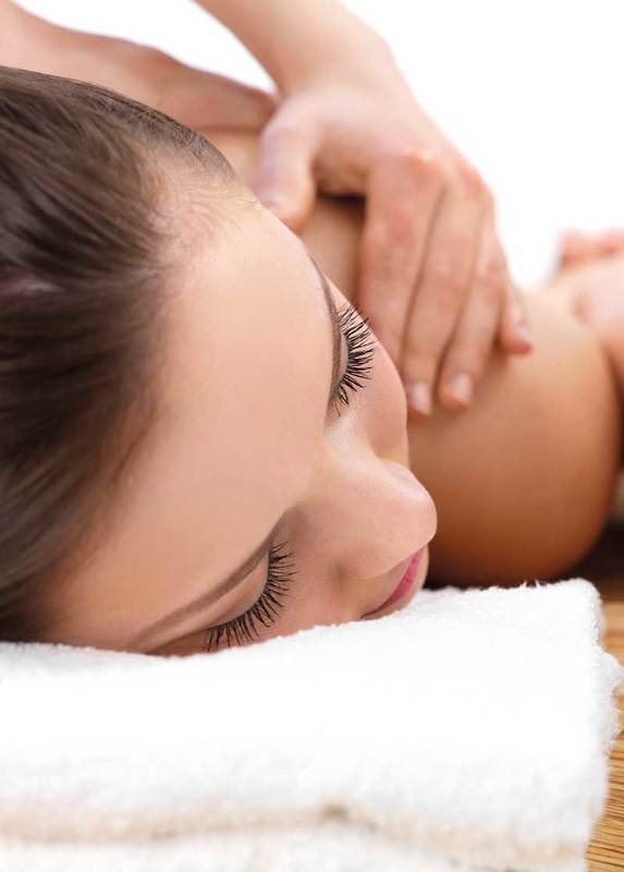 Closeup on relaxed young woman on massage table with apple