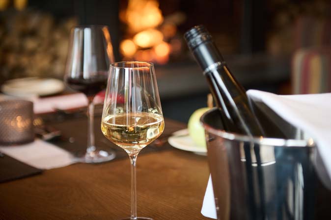 Weiß- und Rotwein im Adams Bistro mit Kamin im Das Hotel Eden Seefeld in Tirol